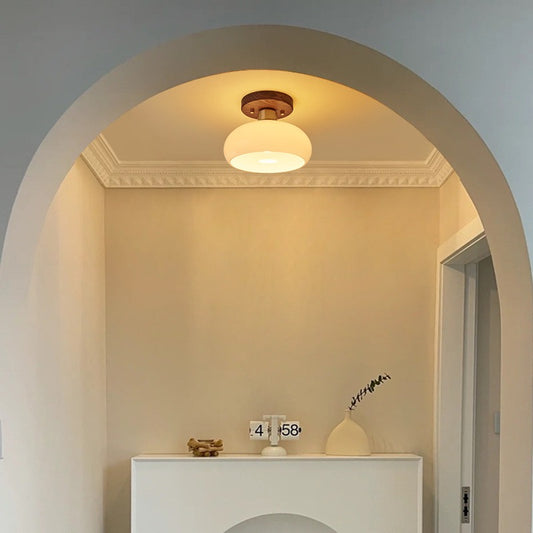 Ceiling light fixture in a room with a decorative archway