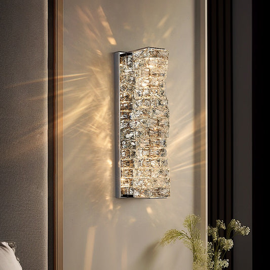 Decorative wall sconce with crystal accents on a neutral wall.