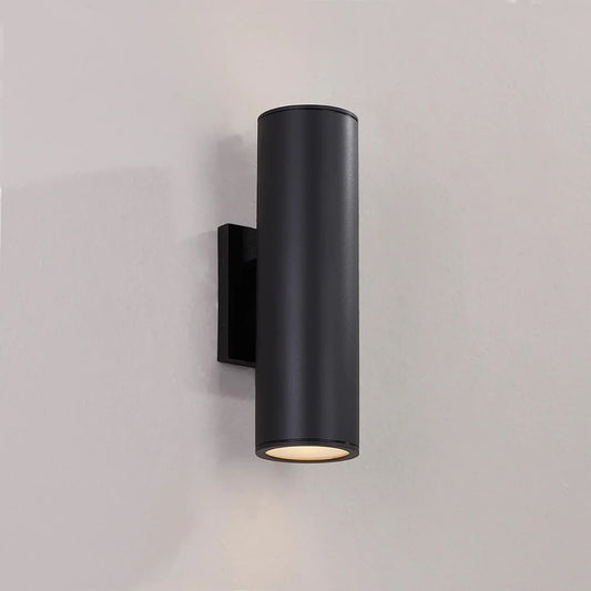 Black cylindrical wall light fixture on a gray background